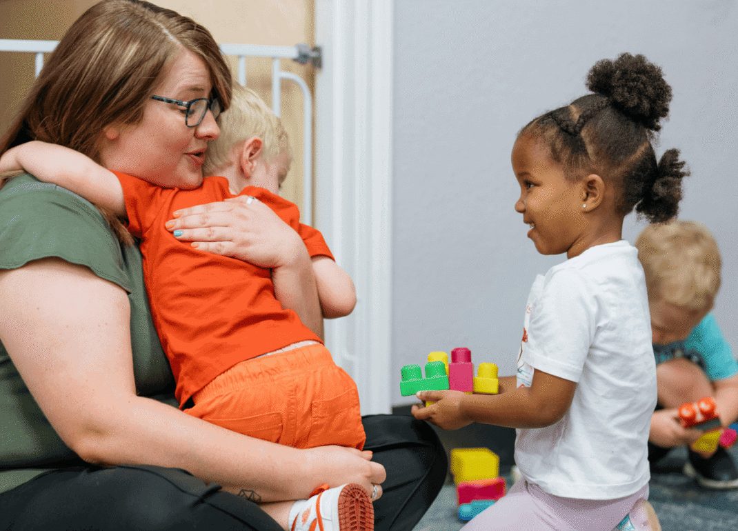 Woman hugging child.